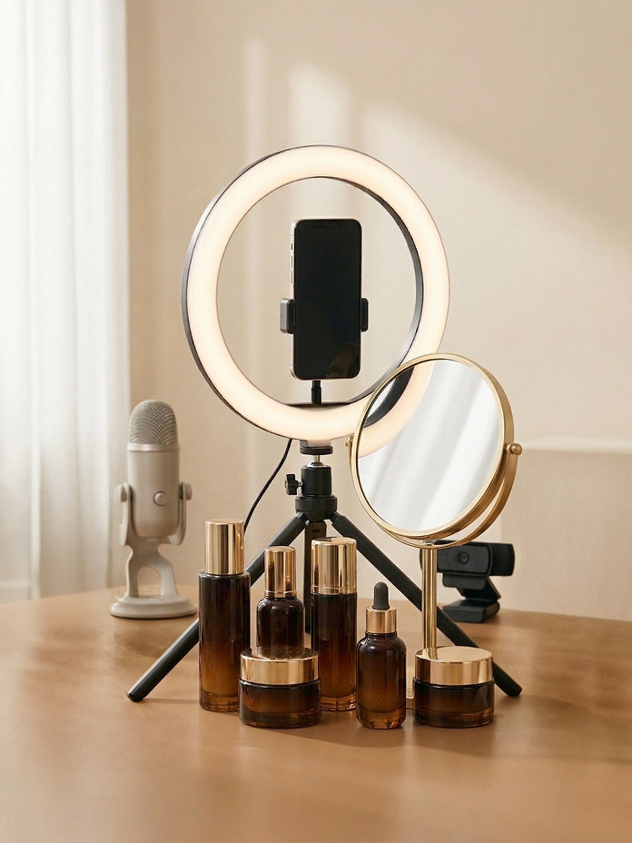 A beauty influencer's workspace featuring a mounted smartphone, studio lighting, a mirror, a microphone, and various cosmetics