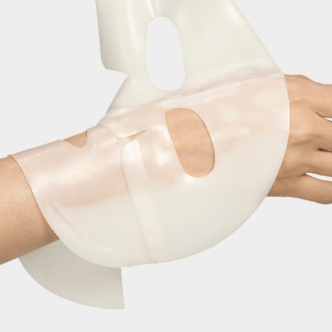 Close-up of a clear, hydrogel-like sheet mask on a hand